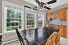 Dining room with light tile patterned floors, ceiling fan, plenty of natural light, and baseboard heating