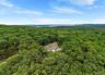 View from above of property featuring a forest