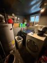 Laundry room with water heater and independent washer and dryer