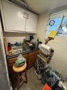 Miscellaneous room with dark tile patterned floors and a sink