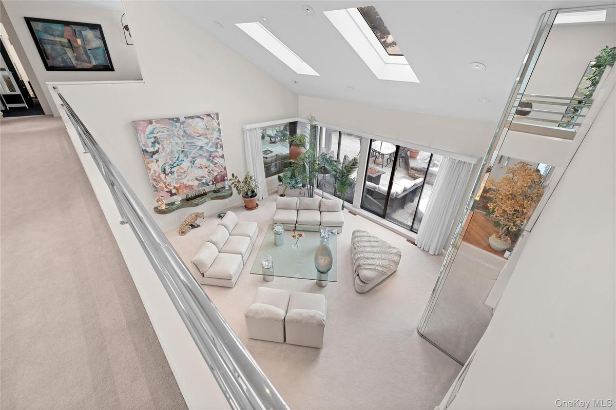 SECOND FLOOR LANDING WITH A VIEW OF FORMAL LIVING ROOM