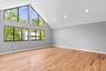 Bedroom featuring baseboards, light wood-type flooring, high vaulted ceiling, and recessed lighting