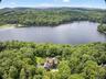 Drone / aerial view of a forest and a nearby body of water