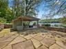 View of patio with a deck with water view and a gazebo