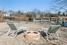 Lounge Chairs outside on the Beach with the Firepit facing the Canal