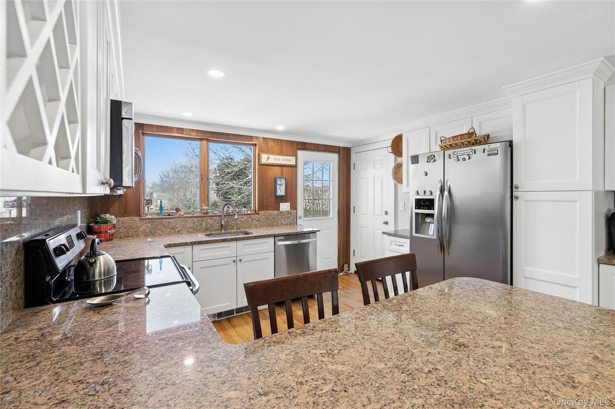 Kitchen with Breakfast Bar facing East into Backyard