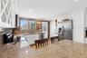 Kitchen with Breakfast Bar facing East into Backyard