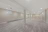 Below grade area featuring a baseboard radiator, light wood-style floors, and recessed lighting