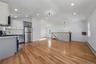 Kitchen featuring stainless steel appliances, baseboard heating, light wood-type flooring, open floor plan, and tasteful backsplash