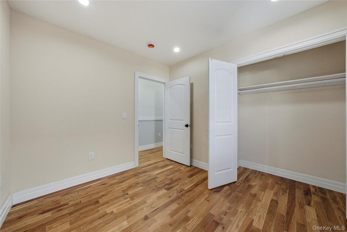 Unfurnished bedroom with light wood-style floors, recessed lighting, and a closet