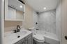 Bathroom featuring vanity, washtub / shower combination, and recessed lighting