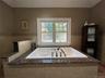 Full bathroom featuring a jetted tub