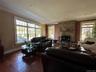 Living room featuring ornamental molding, wood finished floors, and a fireplace