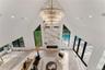 Living room with recessed lighting, a premium fireplace, high vaulted ceiling, and a chandelier