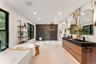 Full bath featuring a walk in shower, double vanity, a freestanding bath, and recessed lighting
