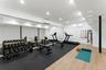 Home gym in basement featuring recessed lighting and a wall mounted air conditioner