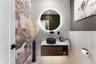 Main Level Half Bath featuring vanity, tile patterned flooring, and tile walls