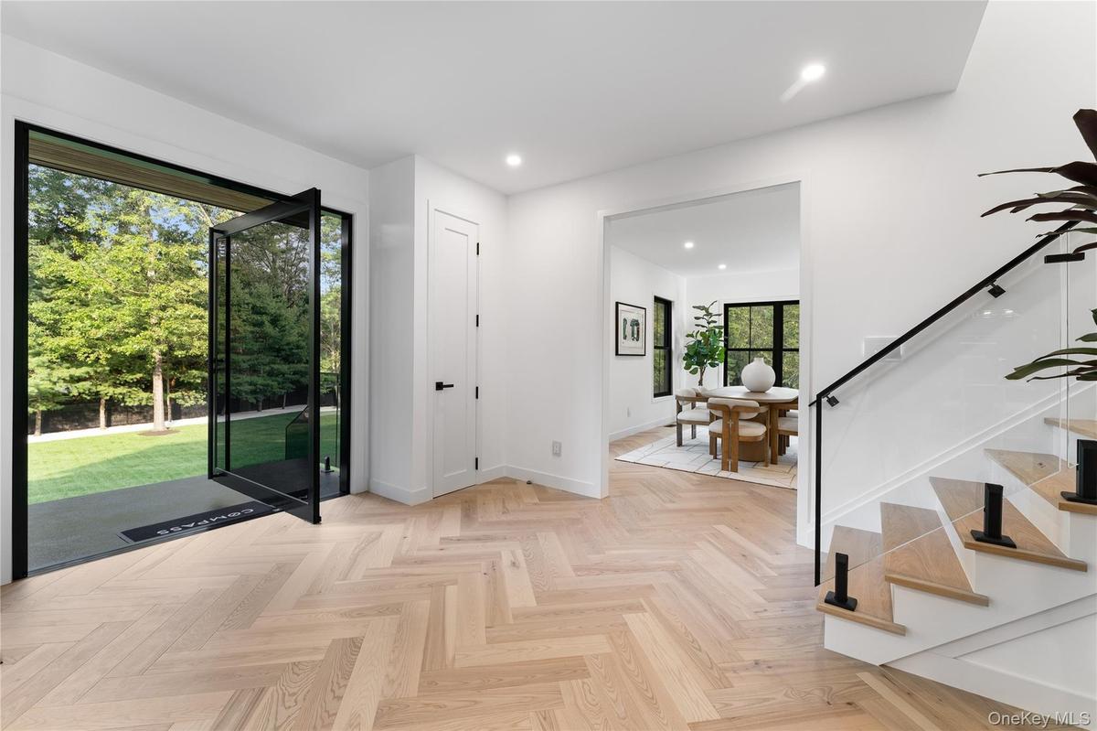 Entryway with recessed lighting and stairs