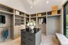 Walk in closet with a chandelier and lofted ceiling