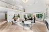 Living room with recessed lighting, high vaulted ceiling, a premium fireplace, and a chandelier