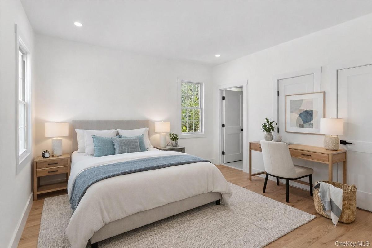 Staged Photo This room features hardwood flooring, recessed lighting, and a window providing natural light
