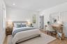 Staged Photo This room features hardwood flooring, recessed lighting, and a window providing natural light