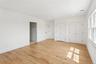 This room features light hardwood floors, white walls, and white trim