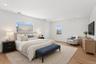Staged Photo Spacious room featuring hardwood floors, recessed lighting, and ample natural light from multiple windows