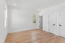 This room features hardwood floors, white walls, and recessed lighting
