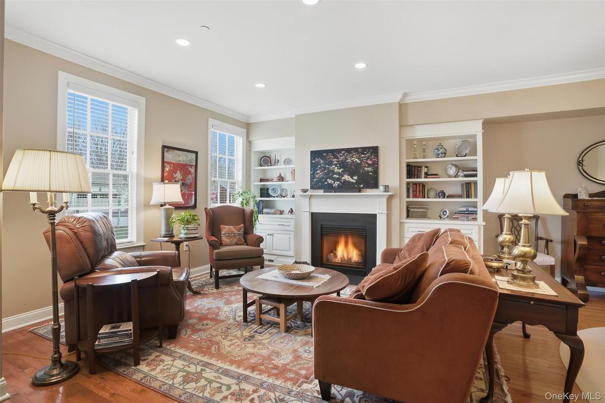 The natural gas fireplace is framed by custom bookcases and cabinets.