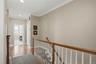 Hardwood oak flooring continues upstairs through the hallway.