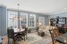 This inviting living area continues present luxury with hardwood floors and windows looking out to patio