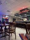 Community bar area featuring a paneled ceiling, track lighting, and tile patterned flooring