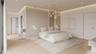 Custom vertical millwork and sculptural lighting define the suite’s refined, modern character. An open, flowing layout enhances both privacy and prese