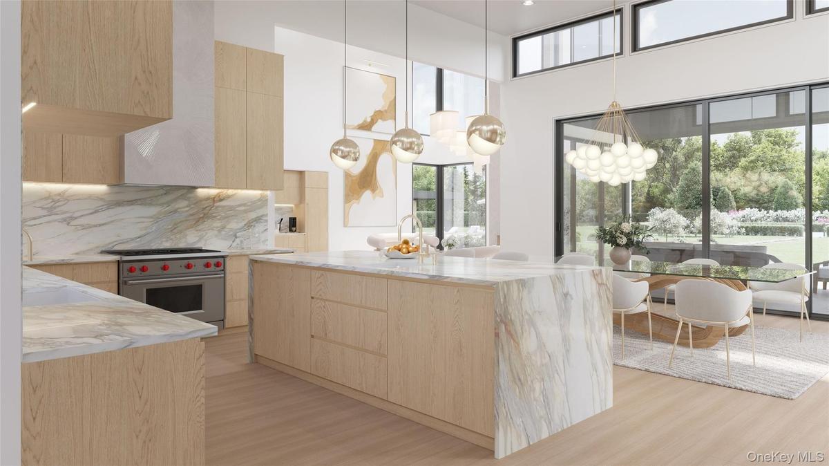 The chef’s kitchen showcases full-height millwork, professional-grade appliances, and an illuminated stone backsplash for a crisp, architectural finis