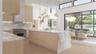 The chef’s kitchen showcases full-height millwork, professional-grade appliances, and an illuminated stone backsplash for a crisp, architectural finis