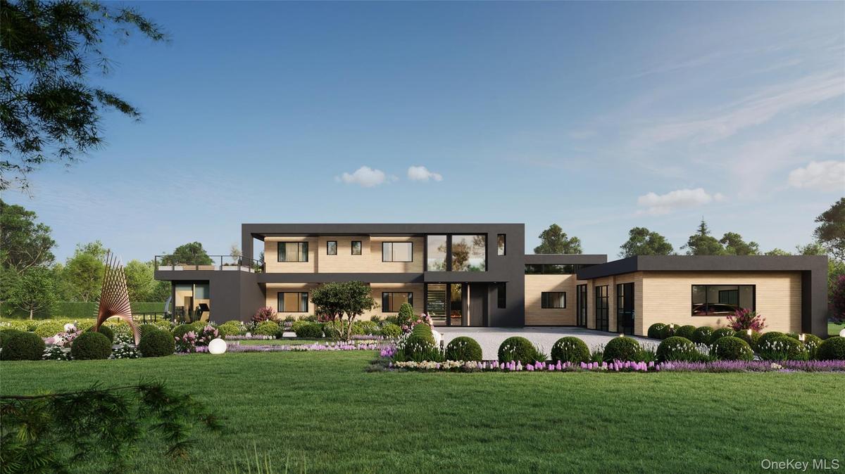 A striking modern façade defined by clean architectural lines, layered landscaping, and a custom pivot entry. The attached two-car garage is seamlessl
