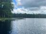 Water view featuring wooded area around the lake