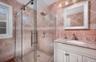 En Suite with single sink vanity, stal shower with glass door entry