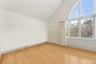 2nd floor bedroom featuring light wood-style flooring and lofted ceiling