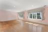2nd floor bedroom featuring baseboard heating, light wood flooring, crown molding, recessed lighting, and a baseboard radiator