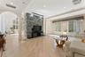 Living area featuring arched walkways, light wood-style flooring, crown molding, and recessed lighting