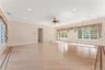 Primary bedroom featuring light wood-style floors, a ceiling fan, recessed lighting, and baseboard heating