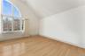 2nd floor room featuring light wood-type flooring and lofted ceiling