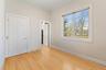 1st floor bedroom featuring crown molding and light wood finished floors