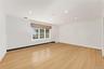 2nd floor bedroom featuring baseboard heating, light wood flooring, crown molding, recessed lighting, and a baseboard radiator