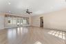 Primary bedroom featuring light wood-style floors, a ceiling fan, recessed lighting, and baseboard heating with a view of the pool