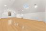 2nd floor recreation room featuring a skylight, light wood-style floors, and baseboard heating