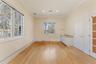 1st floor bedroom with baseboard heating, light wood finished floors, crown molding, and recessed lighting