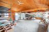 Garage featuring freestanding refrigerator and a workshop area